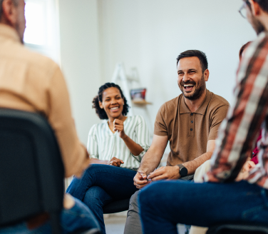 Small group of people seated in a circle at the Healthy Hearts Program.