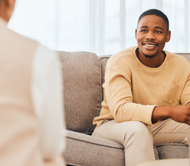 Person suffering from PTSD in a conversation with a mental health practitioner.