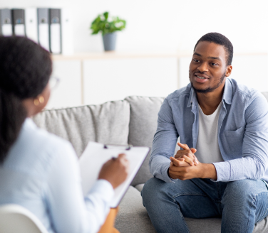 Mental health practitioner in a conversation with a patient in an office.
