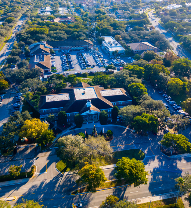 Aerial view of the City of Plantation civic campus surrounded by lush tree canopy and parking areas