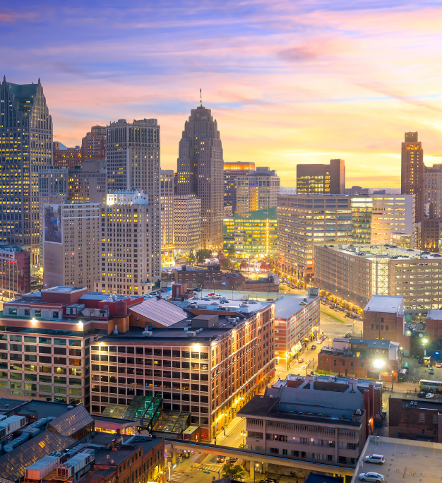 Detroit skyline at dusk with lit high-rise buildings